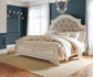 Realyn King Upholstered Panel Bed with Mirrored Dresser