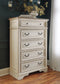 Realyn  Upholstered Panel Bed With Mirrored Dresser And Chest